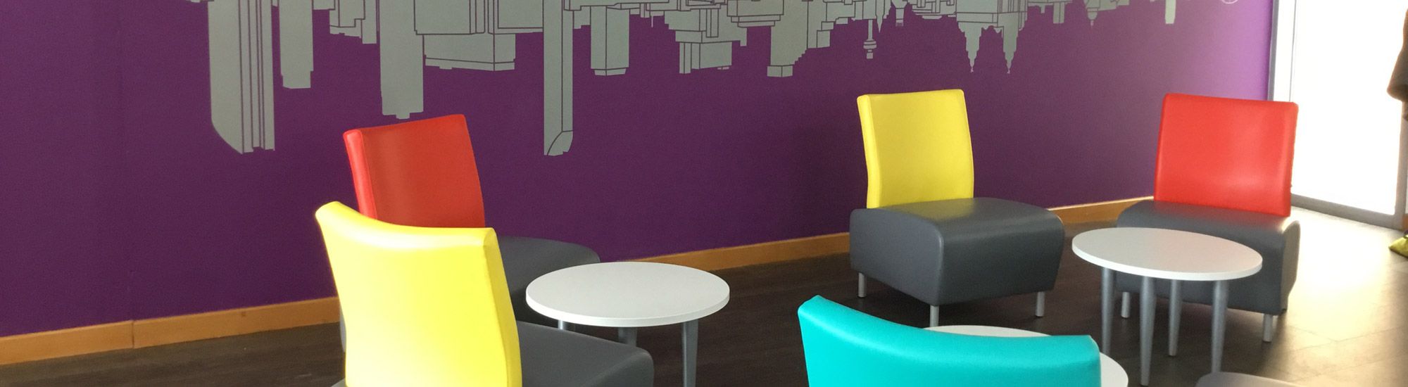 Break room with coloured chairs and tables